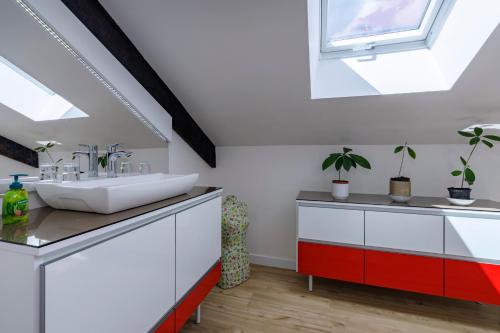 a bathroom with a sink and a window at Au doux passage in Les Rousses