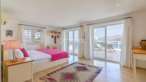 a bedroom with a bed and a view of the ocean at TEKCE Villa Dolly N24 in Kalkan