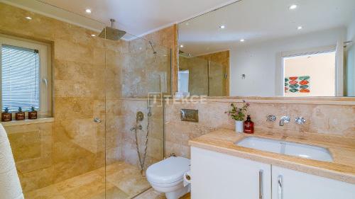 a bathroom with a shower and a toilet and a sink at TEKCE Villa Dolly N24 in Kalkan