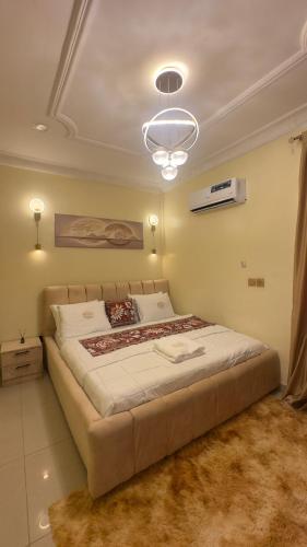 a bedroom with a large bed in a room at Wenggies Apartment in Abuja