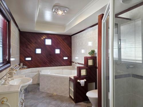 a bathroom with a tub and a toilet and a sink at Milliana House in Wallaroo