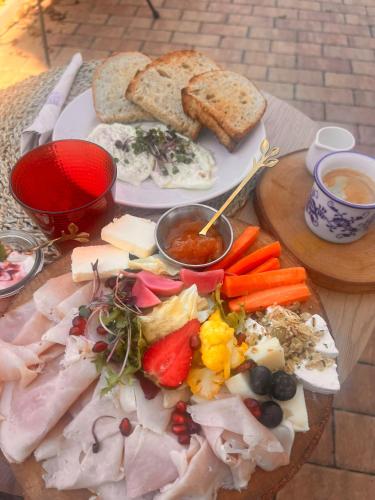 a plate of food with meat and vegetables on a table at Penzion Lederer in Dolní Dunajovice