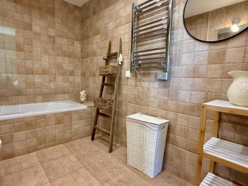 a bathroom with a tub and a sink and a mirror at Casa do Castelo by CORAL in Silves