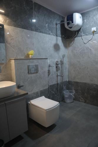 a bathroom with a shower and a toilet and a sink at Hotel Radha Vallabh in Ukhimath