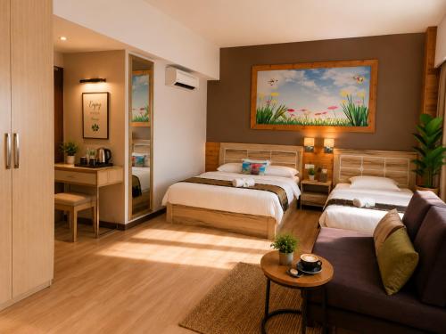 a bedroom with two beds and a couch at INAP Melaka - Suites & Living in Malacca