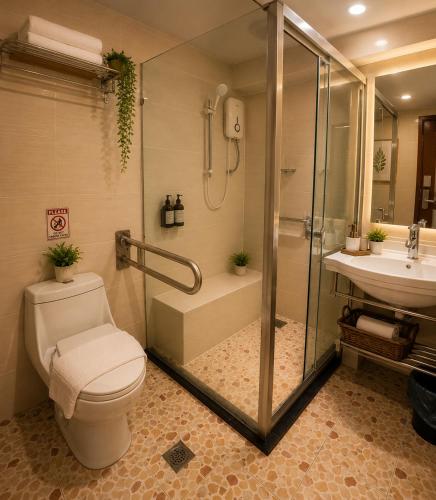 a bathroom with a shower and a toilet and a sink at INAP Melaka - Suites & Living in Malacca