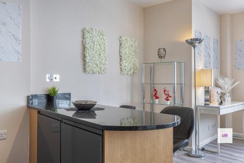 a kitchen with a counter and a refrigerator at Brighton central stylish stays. Walk to the beach. in Brighton & Hove