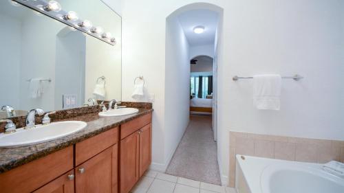 a bathroom with two sinks and a large mirror at 609 Mariners Club in Key Largo
