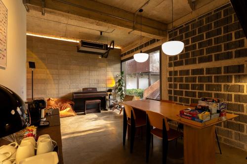 a dining room with a table and a brick wall at Wonderwall Hotel in Chiang Mai
