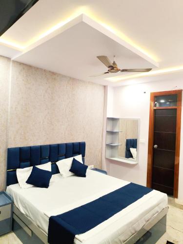 a bedroom with a blue and white bed and a ceiling at Hotel Kashi Bliss in Varanasi