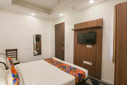 a hotel room with a bed and a tv at FabHotel Signature Luxe Inn - Chhattarpur in New Delhi