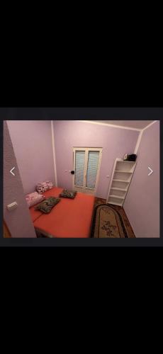 a small room with a bed and a ladder at Rastoder 2 in Donji Štoj