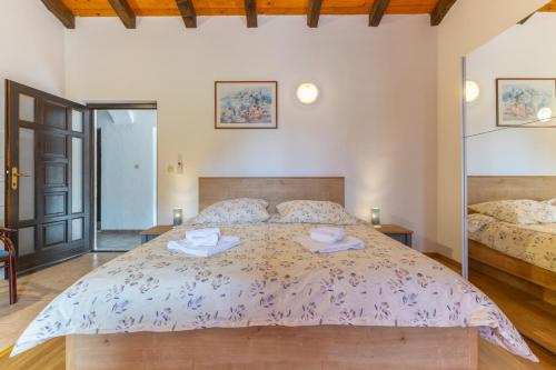a bedroom with a large bed with two plates on it at Casa Oliva in Klostar in Kloštar