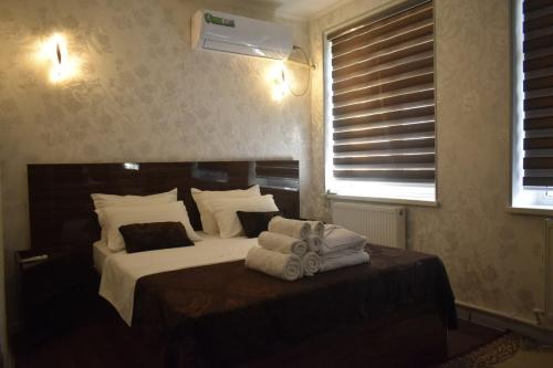 a bedroom with a bed with towels on it at ADMIRAL in Termiz