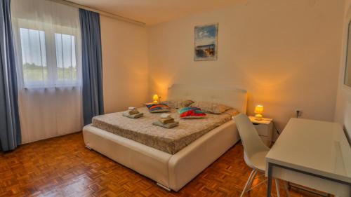 a bedroom with a bed and a table and a desk at Sonnengarten floor 1 in Marčana