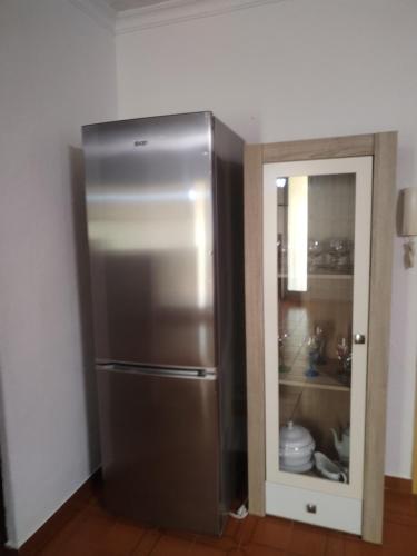 a stainless steel refrigerator in the corner of a kitchen at Chalet Garcia in Deltebre