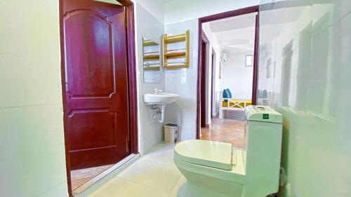 a bathroom with a toilet and a sink at The Safiya Hotel Apartments in Ukunda