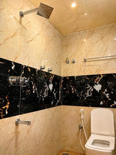 a bathroom with a toilet and a shower at Sunset Villa by Hyatt Stay in Avathi