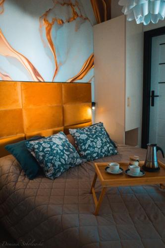 a bedroom with a bed with a coffee table at Appartamento Antares Piazza Fontana in Lignano Sabbiadoro