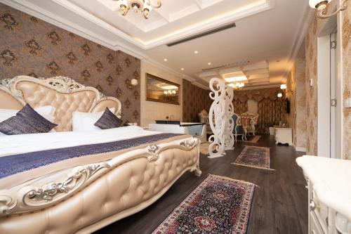 a bedroom with a large bed in a room at Hotel Britania in Tirana