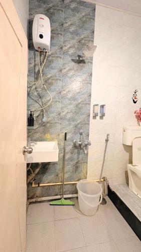 a bathroom with a sink and a toilet in it at Rustic Farm Villa in Chinchavli