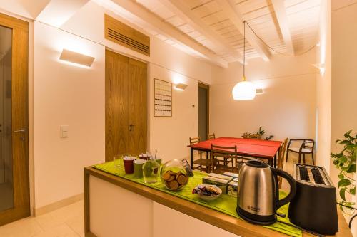 a kitchen with a counter and a table with a kettle at Belle Arti in Bergamo