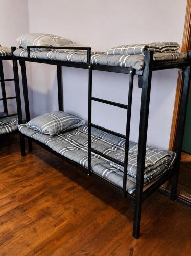 a couple of bunk beds sitting on a wooden floor at Ayvan Eco Hostel in Tashkent