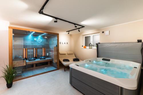 a bathroom with a large tub in a room at Eifel Comfort Luxury Spa Suite mit privatem Whirlpool & Sauna in Pronsfeld