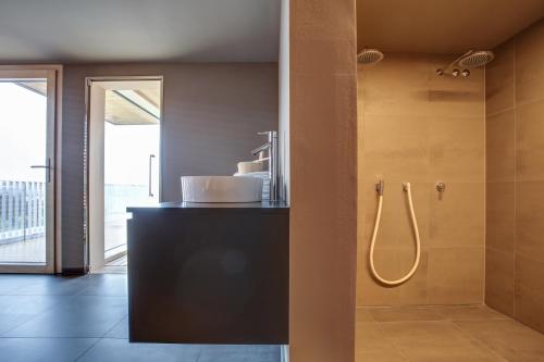 a bathroom with a shower with a sink and a shower at eXo Fly Level 4 Hotel Stuttgart-Flughafen in Ostfildern