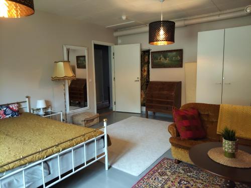 a bedroom with a bed and a living room at Kotamäen Wanha Koulu in Pieksämäki