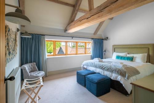 a bedroom with a large bed and a window at Peak Hall in Colkirk
