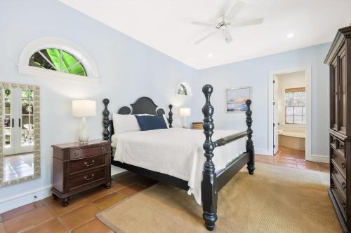 a bedroom with a bed and a ceiling fan at Villa Elena in Captiva