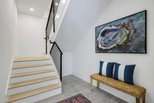 a staircase with a bench and a painting on the wall at Cabana Blu in Captiva
