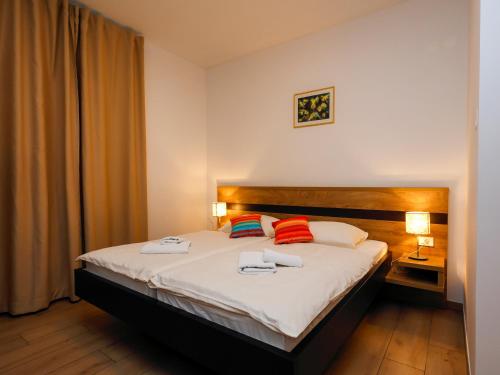 a bedroom with a bed with two towels on it at Guesthouse Rajski okusi Sveta Gora in Solkan