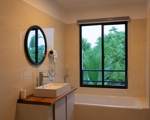 a bathroom with a sink and a large window at Arena Blanca in Rasdhoo
