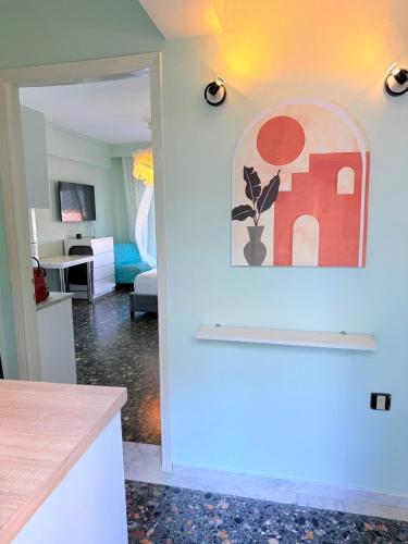 a kitchen and living room with a painting on the wall at Hermes View in Kavála