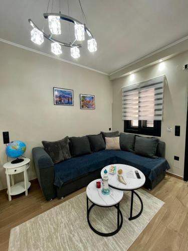 a living room with a blue couch and a table at Apartment Debrova in Alexandroupoli