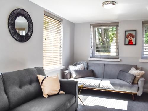 a living room with a couch and a mirror at Summerleaze House in Bude