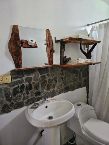 a bathroom with a sink and a toilet at Apu Ecolodge in Caraz