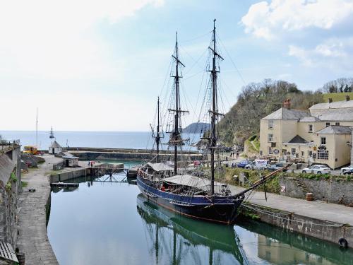 a boat is docked in the water in a harbor at Gwelmor in Charlestown