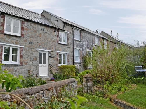 a brick house with a garden in front of it at Gwelmor in Charlestown