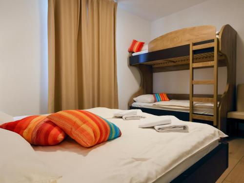 a bedroom with two bunk beds and a ladder at Guesthouse Rajski okusi Sveta Gora in Solkan