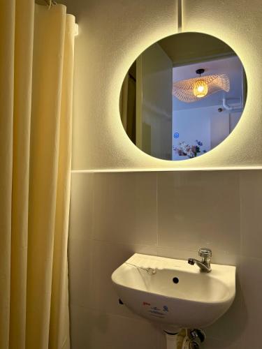 a bathroom with a sink and a mirror at La Casa Del Comienzo- Plumera Mactan Near Airport in Lapu Lapu City