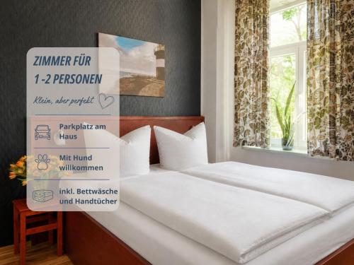 a bedroom with a bed with signs on it at Zimmer Haus Krabbe für Kurzaufenthalt und Geschäftsreise, zwischen Bremerhaven und Cuxhaven in Wremen