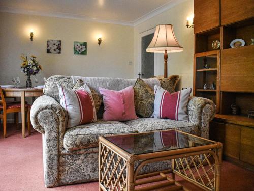 a living room with a couch and a table at New Meadows Cottage in Pickering
