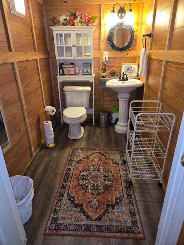 a small bathroom with a toilet and a sink at The Whip-o-Will in Moss Point