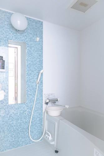 a bathroom with a shower with a toilet in it at The Peak Tengachaya 605 KIX Direct Cozy Elegance near Namba in Osaka