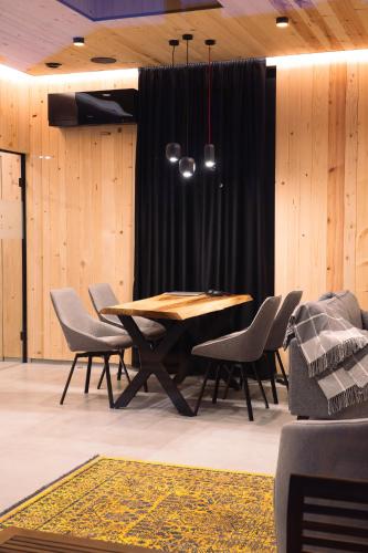 a dining room with a wooden table and chairs at Kabata 2620 ` Кабата 2620 in Bansko