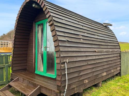 a large wooden house with a green door at Woodpecker Hollow - Uk45980 in Ebchester