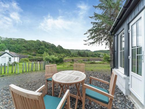 a table and chairs on the porch of a house at Tigh Na Clachan in Clachan
